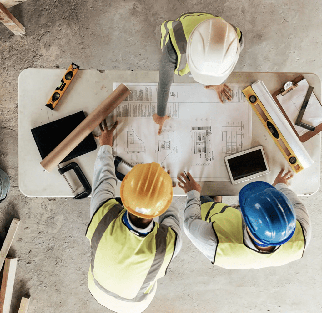 Construction workers reviewing building plans together.